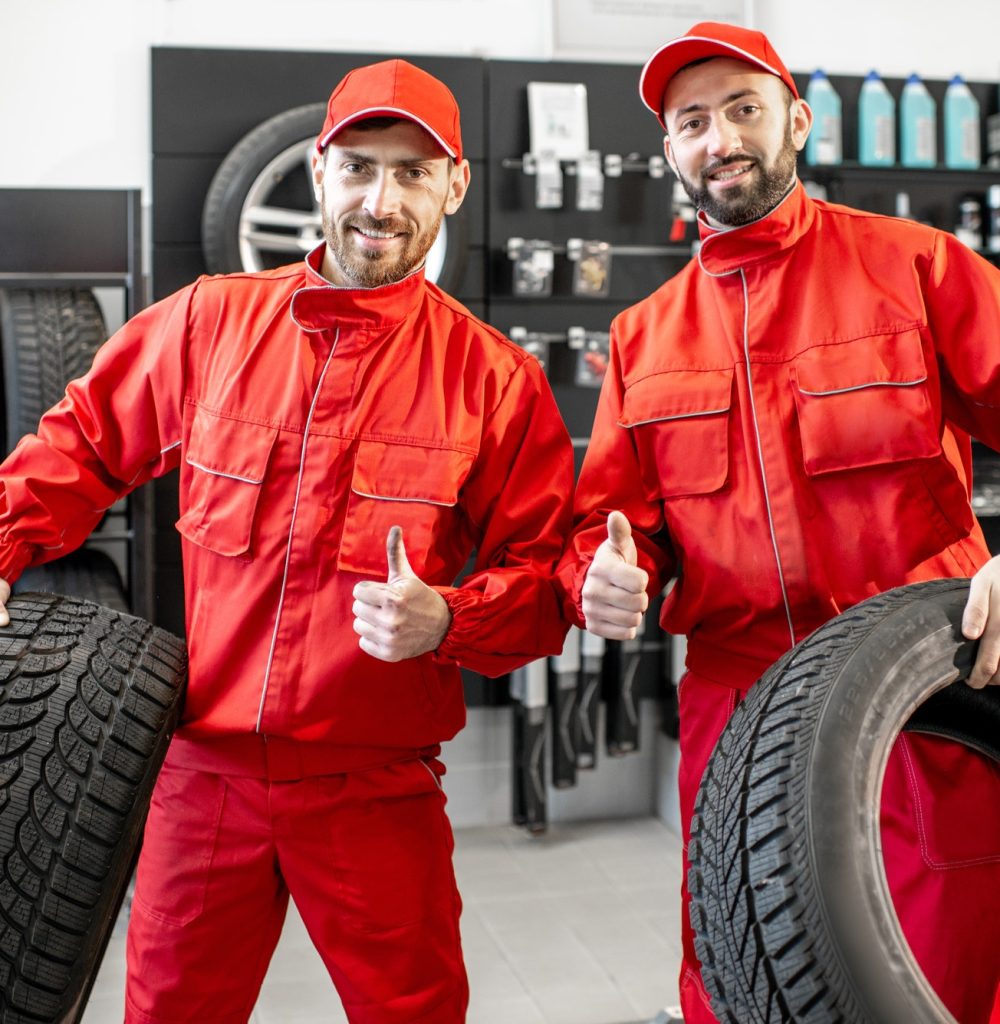 car-service-workers-with-new-tires-at-the-shop.jpg